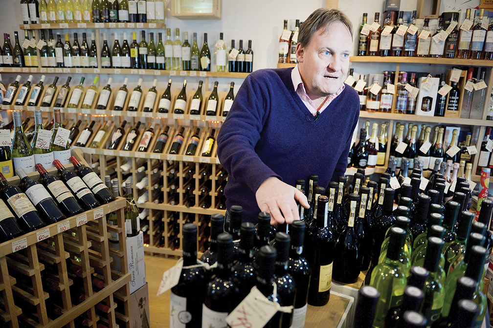 British wine merchant Richard Fox, at his shop in Bucharest in December 2013, welcomes Bulgarians and Romanians who want to work in his home country. He and thousands of other Europeans have settled in Bulgaria and Romania.  
