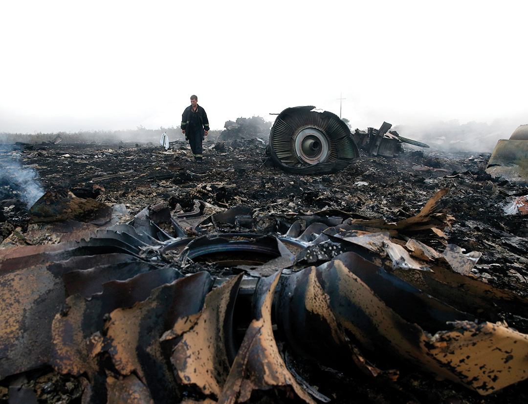 An Emergencies Ministry member walks at the crash site of a Malaysia Airlines Flight MH17 in the Donetsk region of eastern Ukraine in July 2014. The plane was brought down by a Russian-made missile, killing all 295 passengers. REUTERS