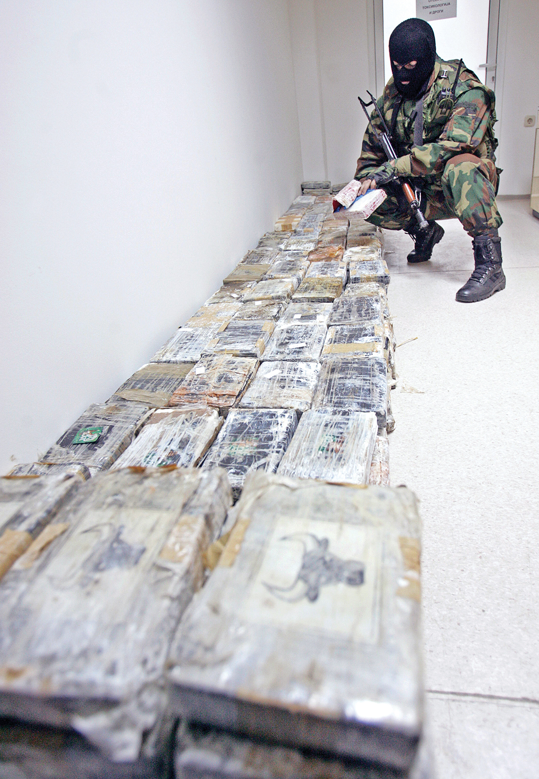A Macedonian police officer examines cocaine seized from a truck at a border crossing with Kosovo. AFP/GETTY IMAGES